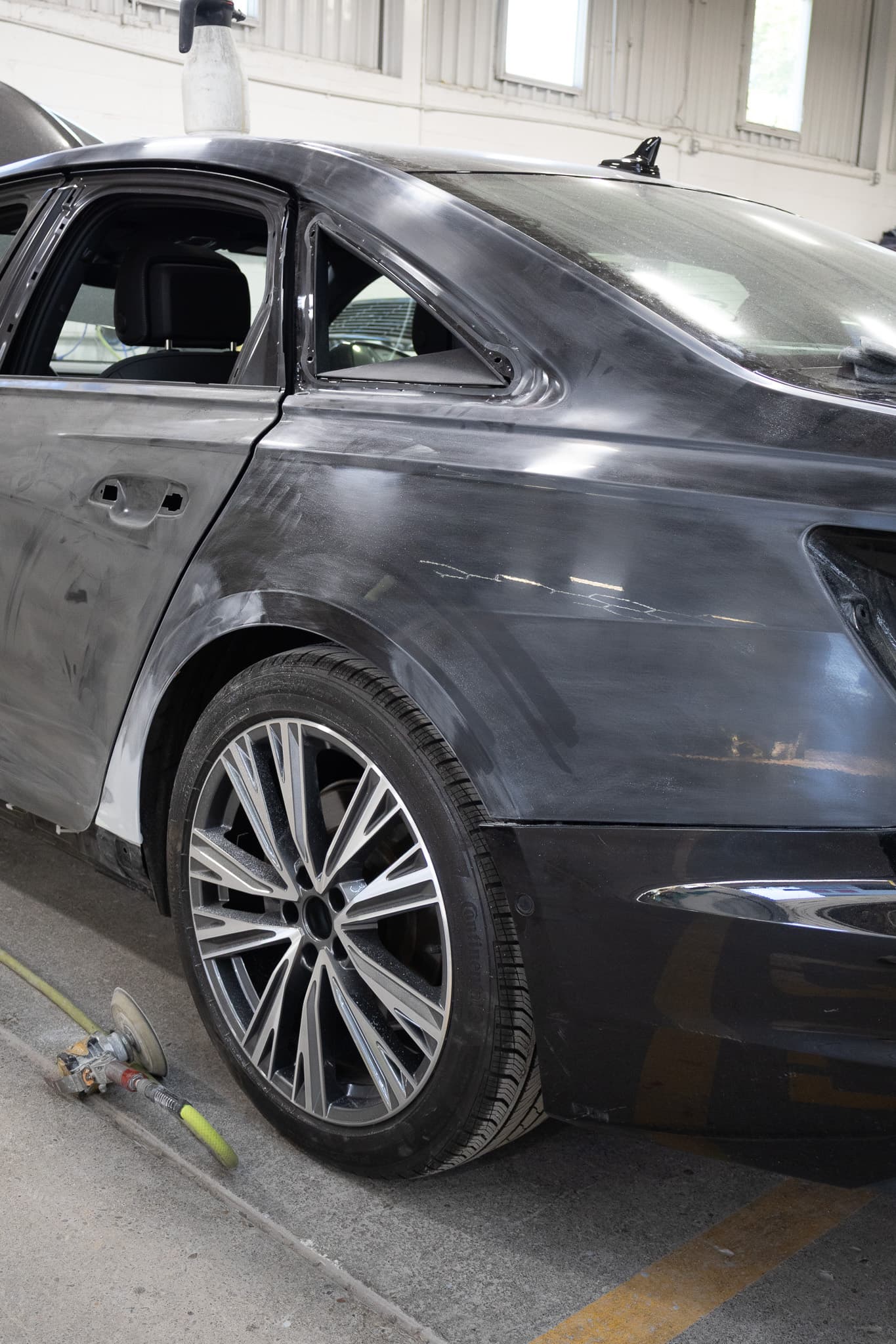 Black Audi sanded and primed during collision repair at Autometric Body & Paint